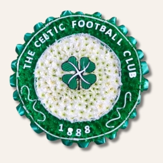 Celtic badge funeral tribute with white chrysanthemum base, green spray detail, laminated accents and green ribbon edging, 23 inch, ideal for Celtic FC fans.