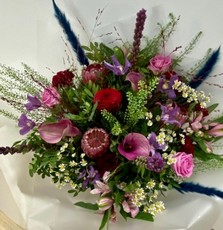 Ruby Jewel bouquet with roses, calla lily, clematis, liatris and pampas grass in jewel-toned shades.